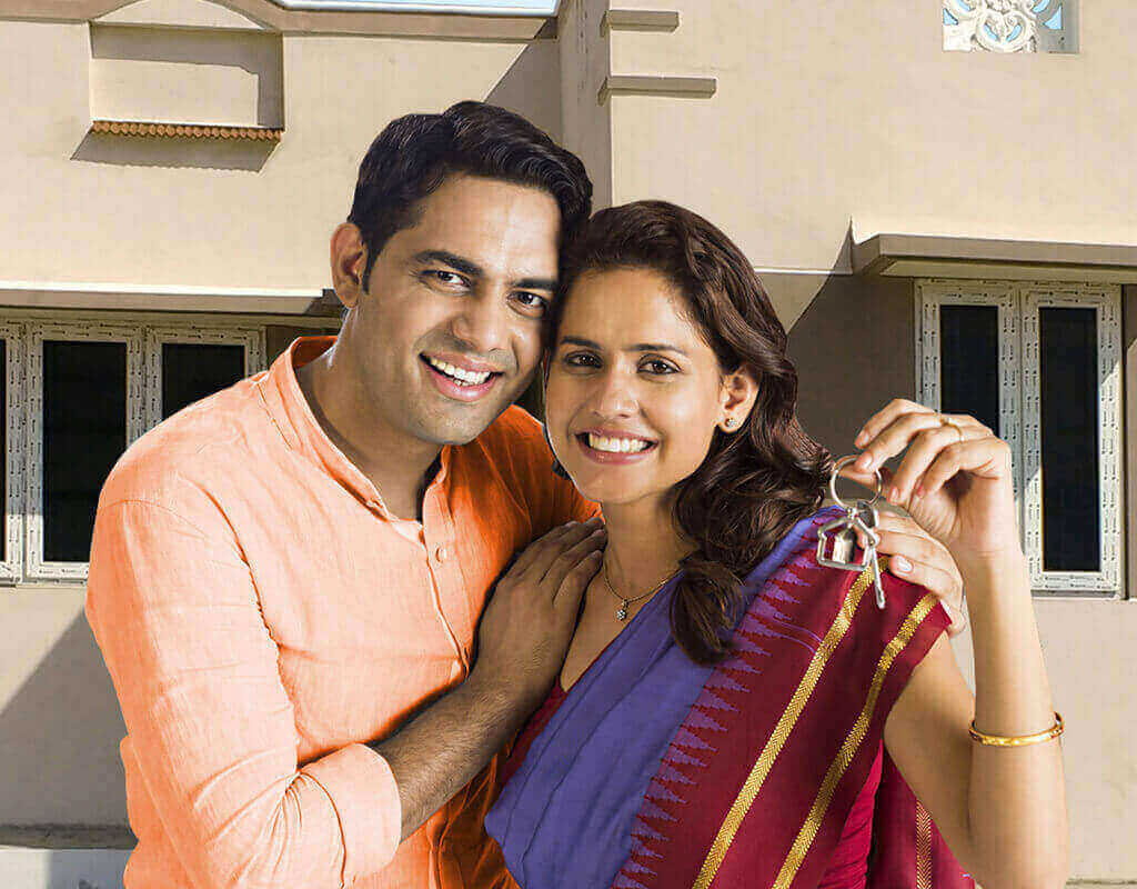 Happy Young Couple Holding Keys of New Home